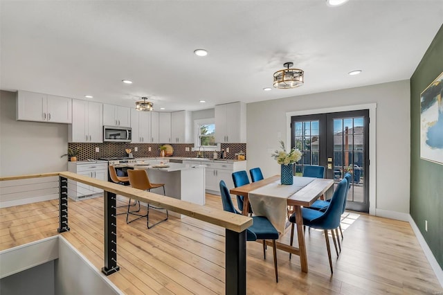 dining area with french doors, recessed lighting, baseboards, and light wood-type flooring
