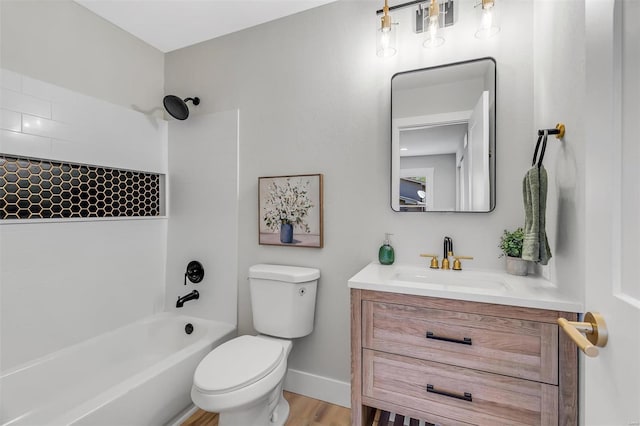 full bath featuring vanity, wood finished floors, toilet, baseboards, and shower / bath combination
