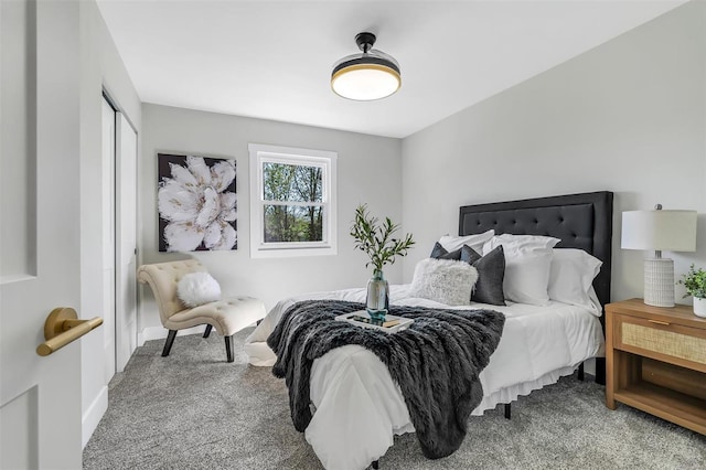 bedroom with a closet, carpet flooring, and baseboards