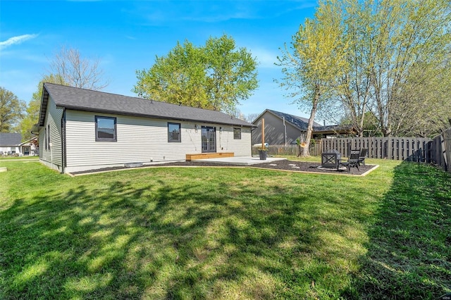 back of house featuring a patio, a yard, and fence private yard