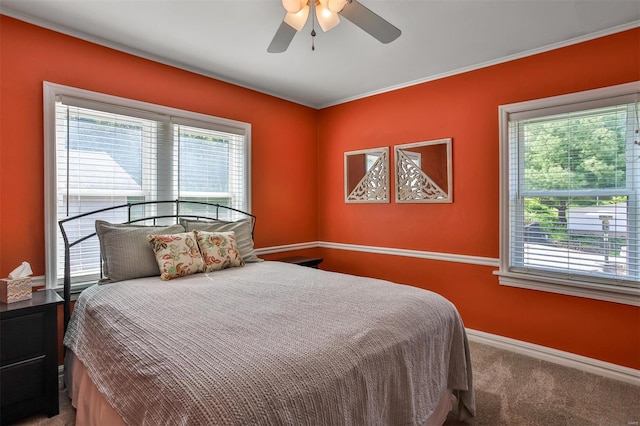 bedroom featuring baseboards, crown molding, carpet, and ceiling fan