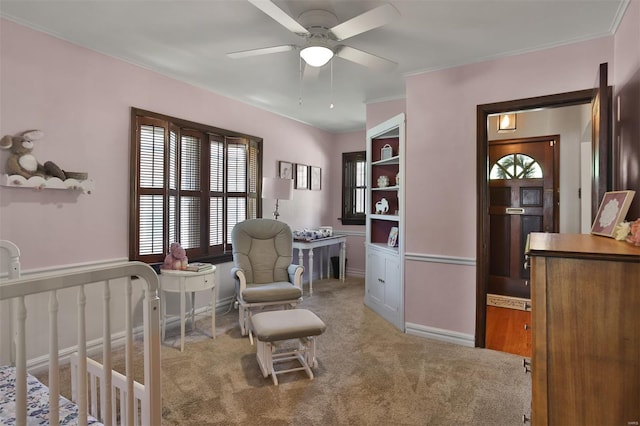 carpeted bedroom with crown molding, multiple windows, and a ceiling fan