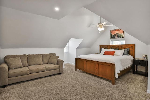 bedroom with light colored carpet, vaulted ceiling, and multiple windows