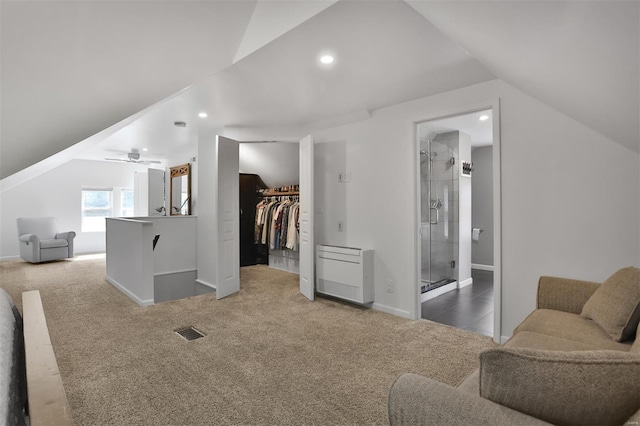 interior space with carpet flooring, baseboards, visible vents, and lofted ceiling