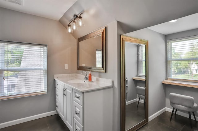 bathroom with baseboards, tile patterned flooring, vanity, and visible vents
