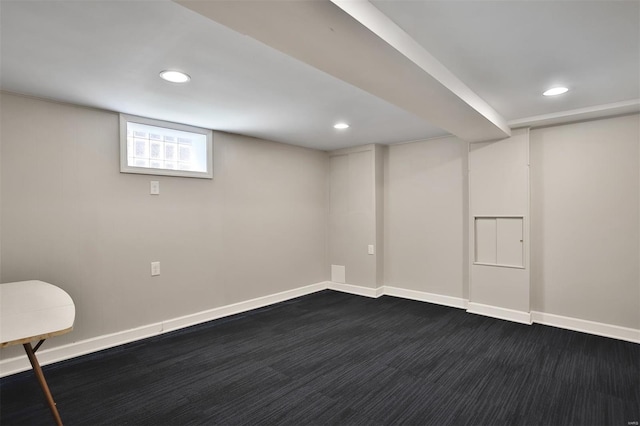 basement featuring recessed lighting, baseboards, and dark carpet