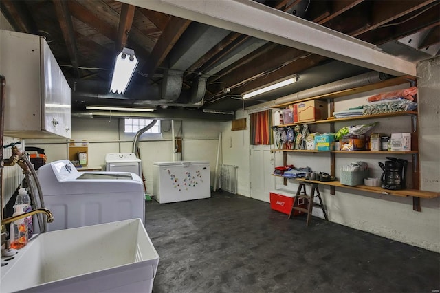 basement with washing machine and dryer and a sink