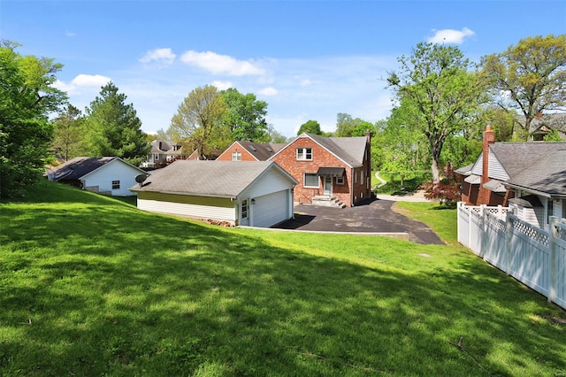 exterior space with a yard, brick siding, and fence