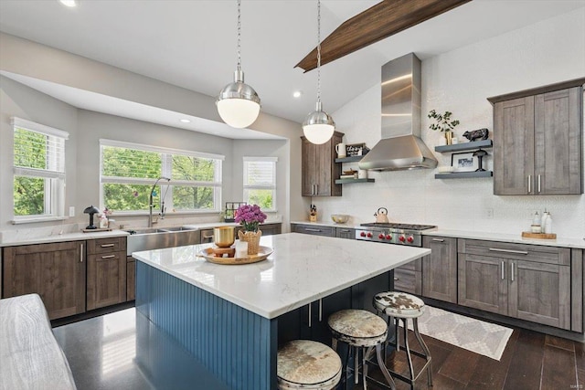kitchen with open shelves, wall chimney range hood, recessed lighting, a sink, and backsplash