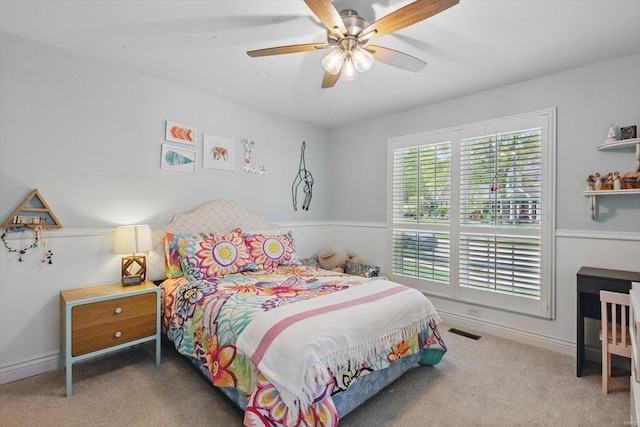 bedroom with a ceiling fan and carpet