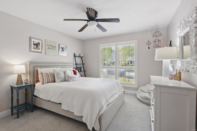 bedroom featuring baseboards, ceiling fan, and light carpet