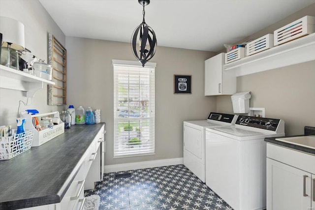 laundry area featuring washer and dryer, baseboards, dark floors, a sink, and cabinet space