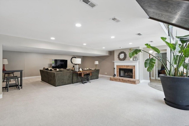 living room featuring visible vents, baseboards, and light colored carpet