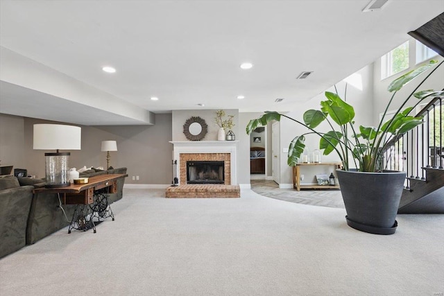 carpeted living area featuring baseboards, recessed lighting, a brick fireplace, and visible vents