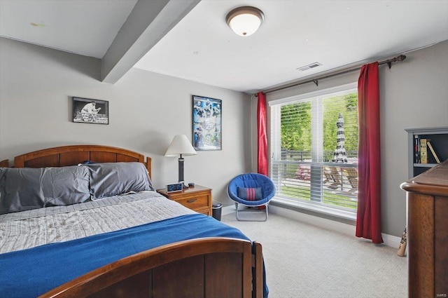 bedroom featuring baseboards, visible vents, and carpet