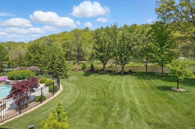 view of yard featuring a fenced in pool and fence