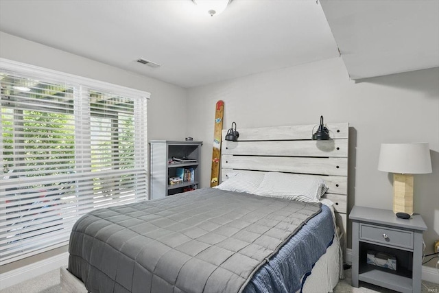 carpeted bedroom featuring baseboards and visible vents