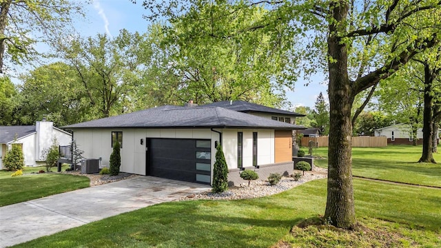 view of home's exterior featuring a lawn, brick siding, central AC, and driveway