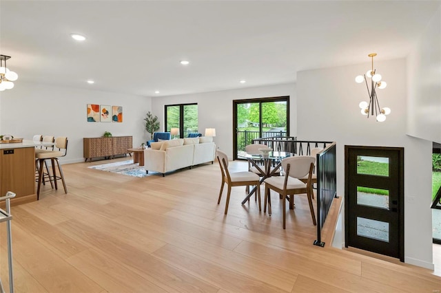 dining room featuring recessed lighting, an inviting chandelier, and light wood-type flooring