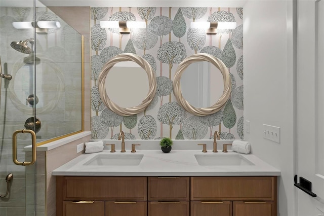bathroom featuring a sink, a shower stall, and double vanity