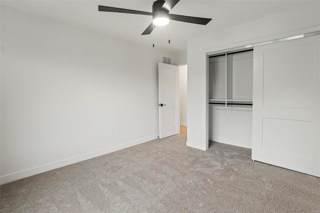 unfurnished bedroom with baseboards, carpet, a closet, and visible vents