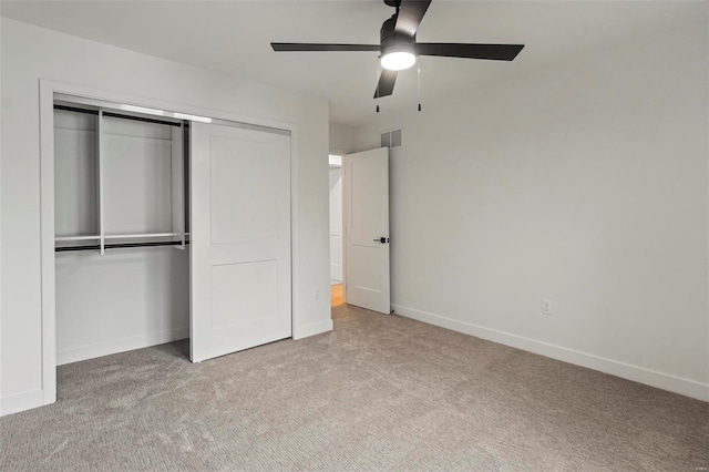 unfurnished bedroom with a closet, a ceiling fan, visible vents, baseboards, and carpet flooring