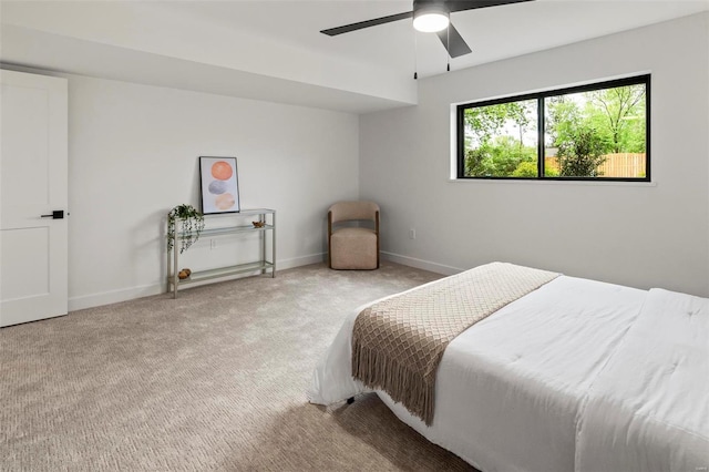 carpeted bedroom featuring a ceiling fan and baseboards