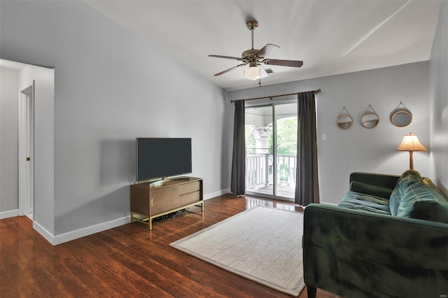 living area with baseboards, ceiling fan, and wood finished floors