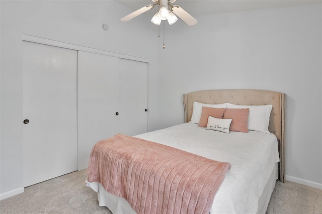 bedroom featuring a closet, baseboards, ceiling fan, and carpet flooring