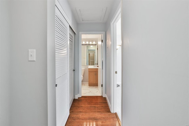 hallway with baseboards and marble finish floor