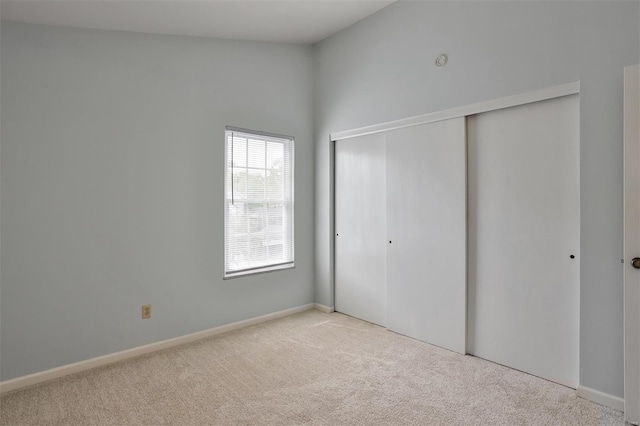 unfurnished bedroom featuring a closet and carpet flooring