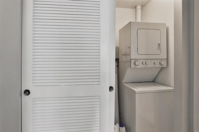laundry area featuring stacked washer and dryer and laundry area