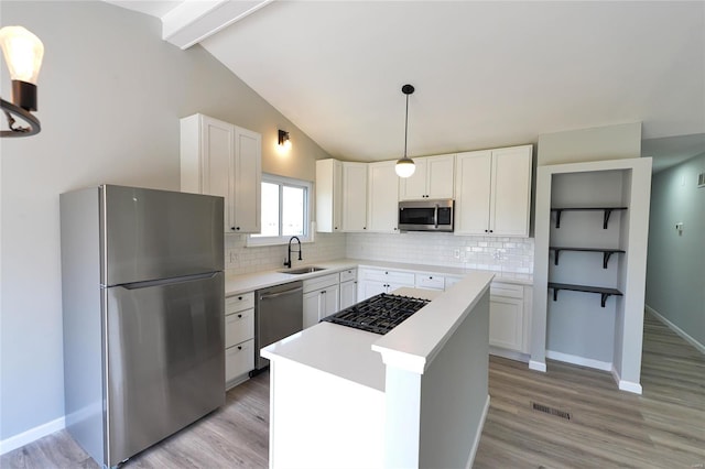 kitchen featuring backsplash, appliances with stainless steel finishes, visible vents, and a sink