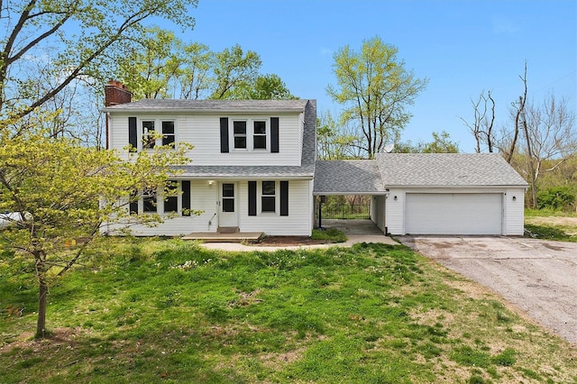 view of front of house with a garage, a front yard, a chimney, covered porch, and driveway