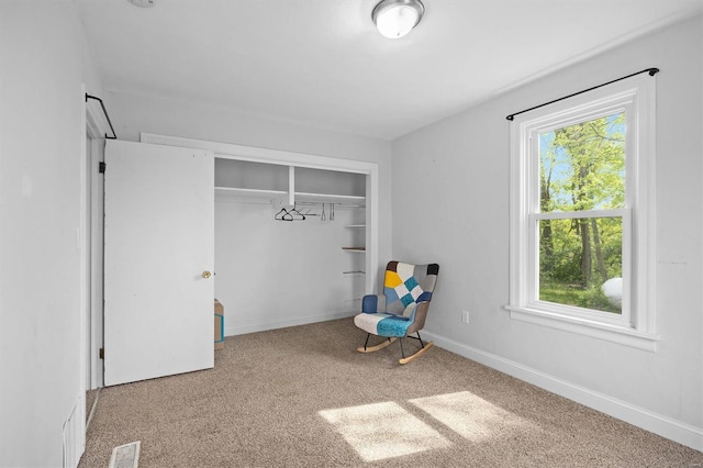 unfurnished bedroom featuring visible vents, carpet flooring, a closet, and multiple windows