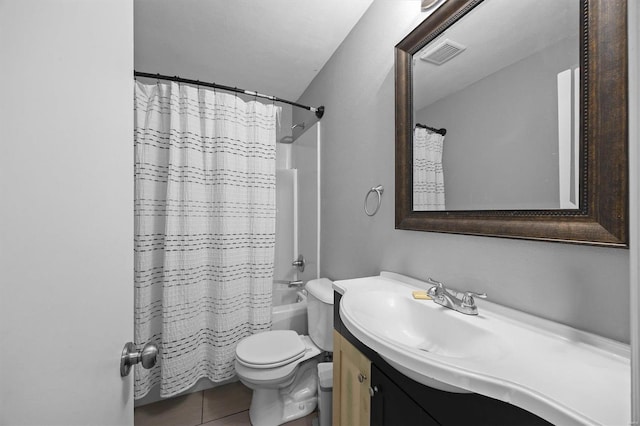 full bathroom featuring visible vents, vanity, toilet, tile patterned floors, and shower / tub combo