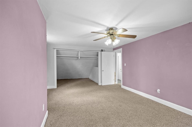 unfurnished bedroom featuring a closet, baseboards, carpet floors, and ceiling fan