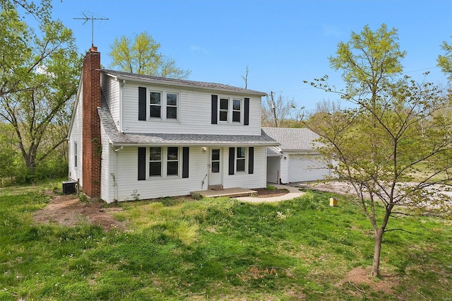 traditional home with an attached garage, a front yard, covered porch, and a chimney