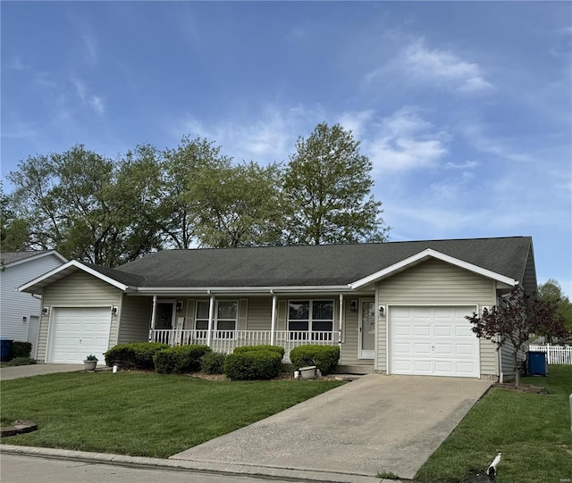 single story home featuring covered porch, an attached garage, and driveway