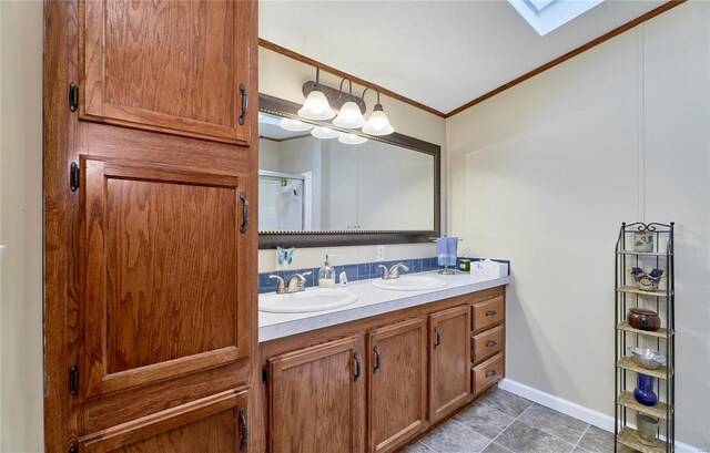 full bath featuring a sink, a skylight, ornamental molding, and double vanity