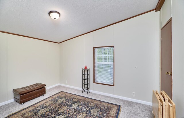 empty room featuring crown molding, carpet floors, a textured ceiling, baseboards, and lofted ceiling