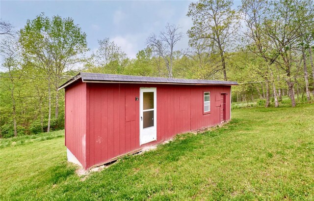 view of outbuilding featuring an outbuilding and a wooded view