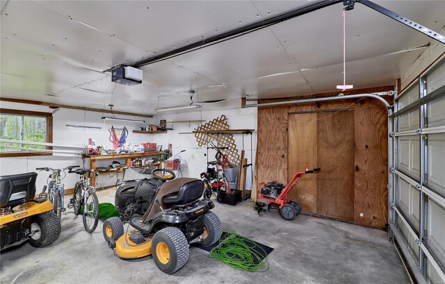 garage with a workshop area and a garage door opener