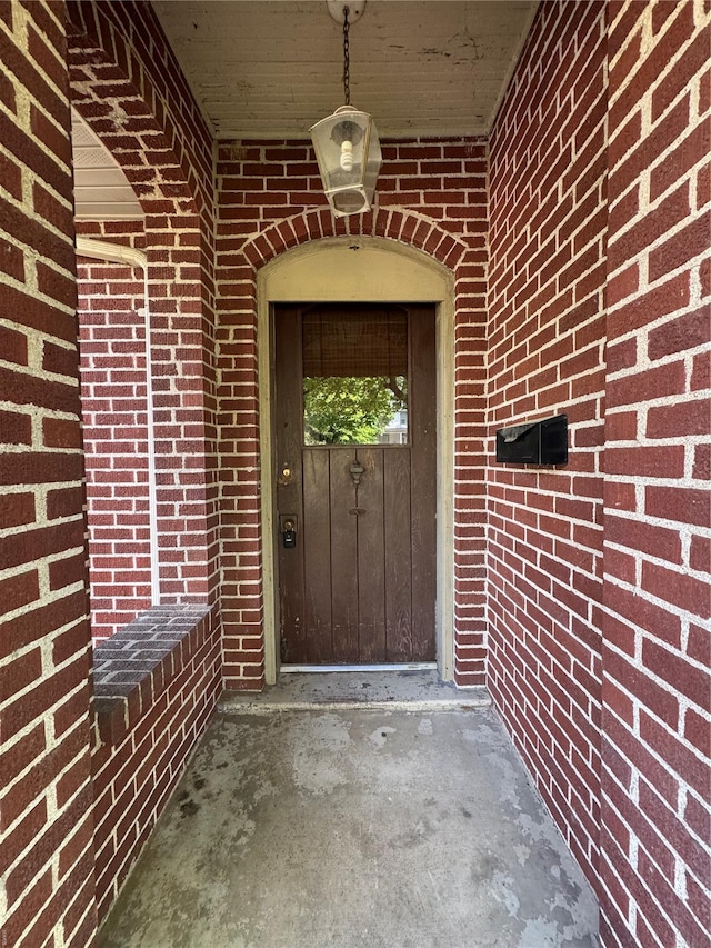 property entrance with brick siding