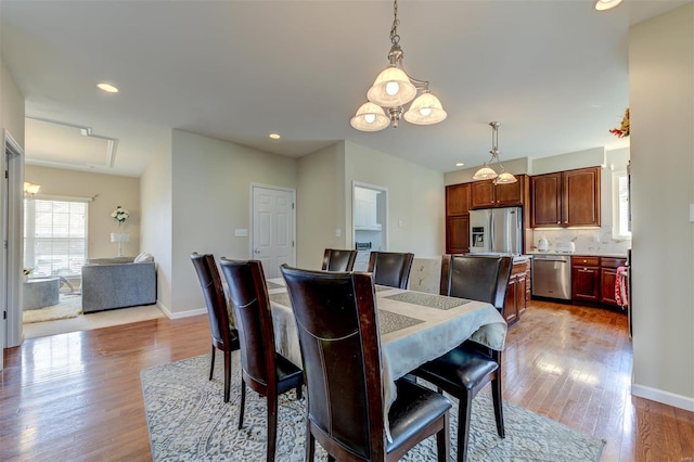 dining room with recessed lighting, baseboards, and wood finished floors