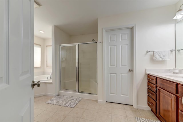 bathroom with vanity, a garden tub, tile patterned flooring, and a shower stall
