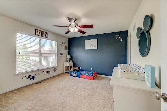 rec room with carpet flooring, a ceiling fan, baseboards, and visible vents