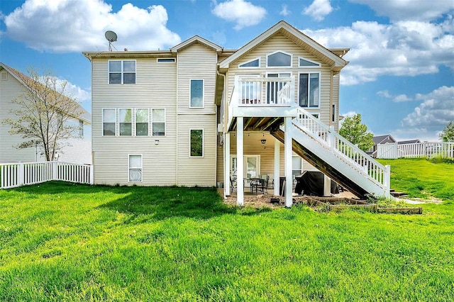 back of property with a lawn, fence private yard, stairway, and a patio area