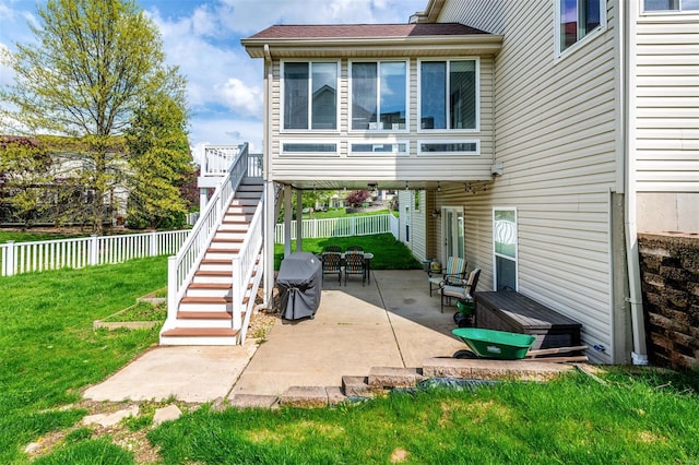 back of property featuring a lawn, a patio, a fenced backyard, and stairs