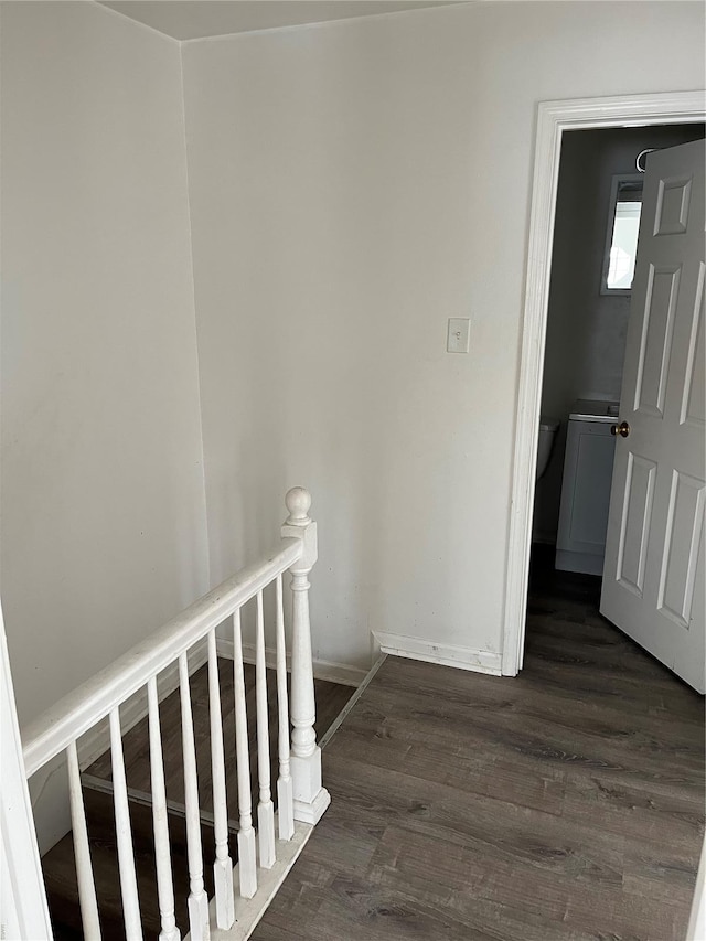 staircase with baseboards and wood finished floors